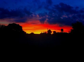 Silhouette landscape against sky at sunset