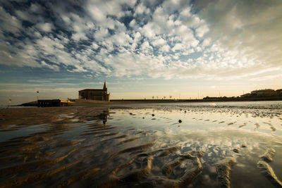 Panoramic view of sea and buildings against sky