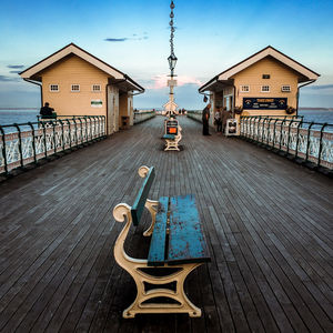 Lifeguard hut by sea against sky
