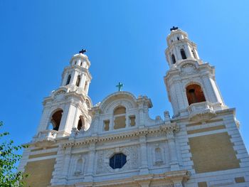 Low angle view of church against clear blue sky