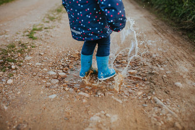 Low section of child standing on ground