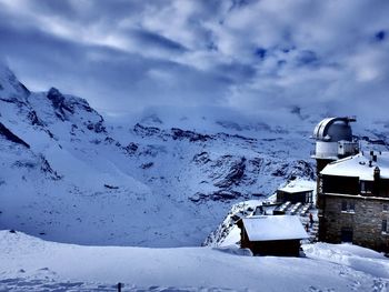 Gornergrat and snowcapped mountains against cloudy sky