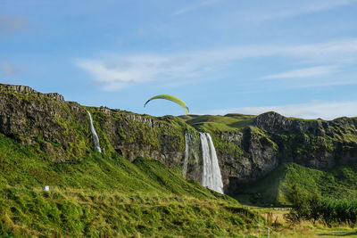 Scenic view of waterfall against sky