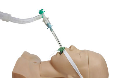 Close-up of woman holding umbrella against white background