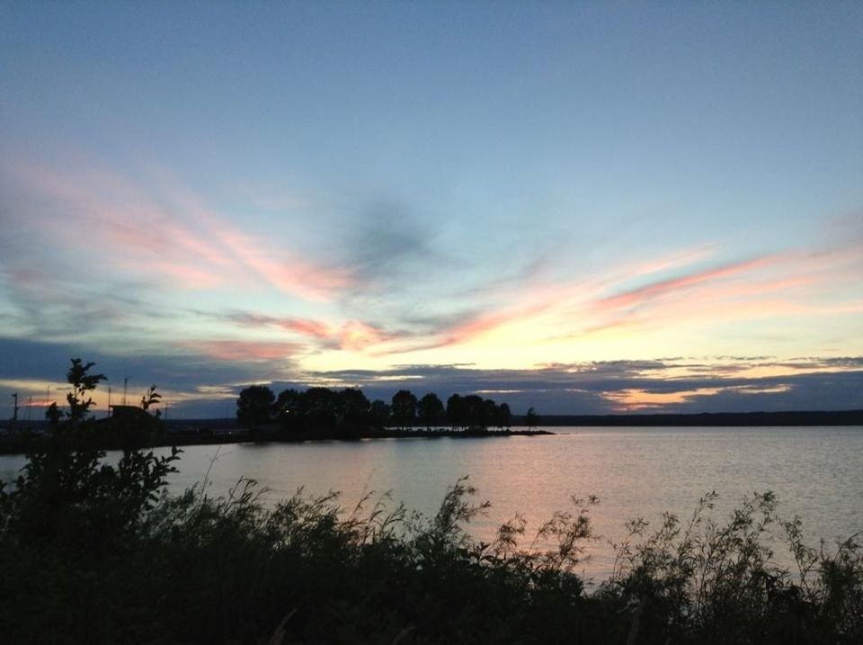 sunset, water, tranquil scene, tranquility, scenics, sky, beauty in nature, lake, reflection, silhouette, nature, idyllic, orange color, cloud - sky, cloud, plant, calm, outdoors, dusk, no people