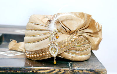 Close-up of hat on table against white background