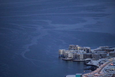 High angle view of cityscape by sea against sky