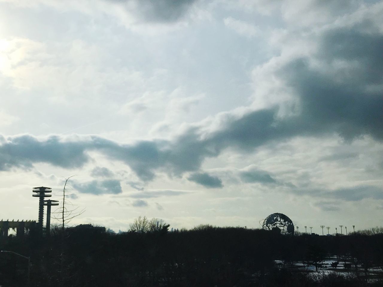 SILHOUETTE OF FACTORY AGAINST SKY