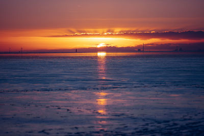 Scenic view of sea against romantic sky at sunset