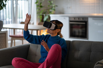 Adult caucasian woman use vr glasses for entertainment and games with augmented reality technology