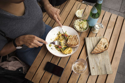 High angle view of woman having lunch at sidewalk cafe table