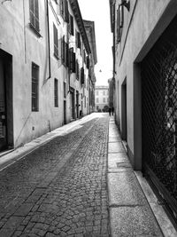 Alley amidst street in city