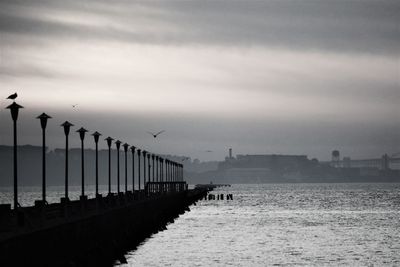 Pier on sea against sky