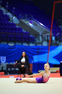 Gymnastics and ball between legs of performance, competition training or dancing
