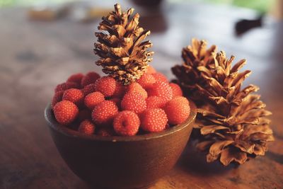 Close-up of berry fruits in bowl on table