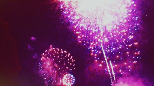 Low angle view of firework display at night