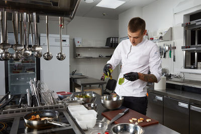 Full length of man working in kitchen