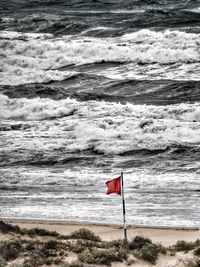 Lifeguard hut on beach against sky