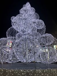 Close-up of illuminated lighting against sky at night