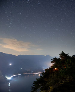 Scenic view of illuminated mountains against sky at night