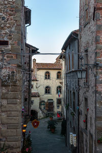 Canal amidst buildings in town against sky