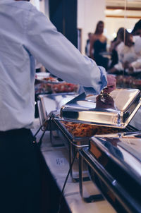 Midsection of man preparing food