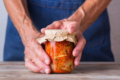 Midsection of man preparing food on table