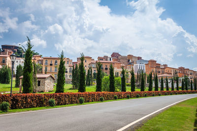 Panoramic shot of road amidst buildings against sky