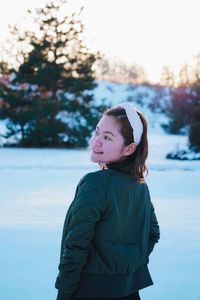 Full length of woman standing against sky during winter