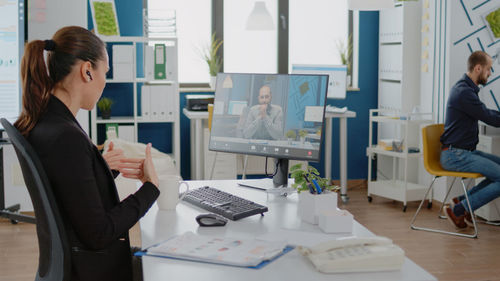 Businesswoman talking on video call in office
