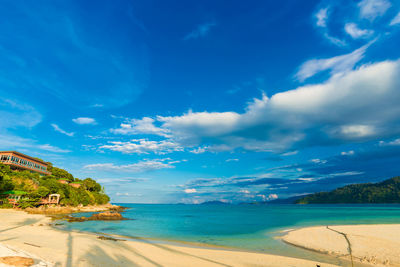 Scenic view of beach against cloudy sky