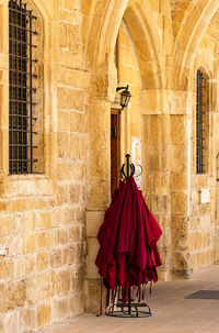 Red umbrella against wall of building