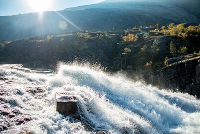 Aerial view of waterfall against sky