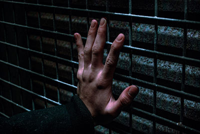 Close-up of man touching metal
