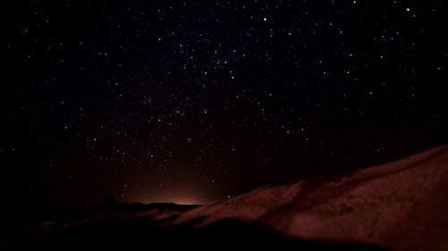 Scenic view of mountains against sky at night