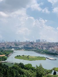 High angle view of river and buildings against sky