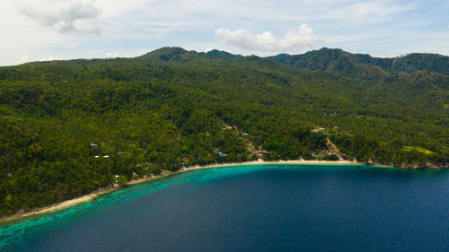 Scenic view of sea and mountains against sky