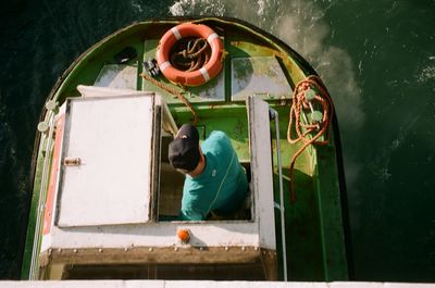 High angle view of man working in boat