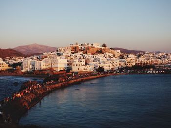 Town by sea against clear sky