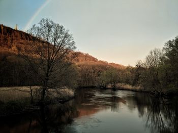 Scenic view of lake in forest against sky