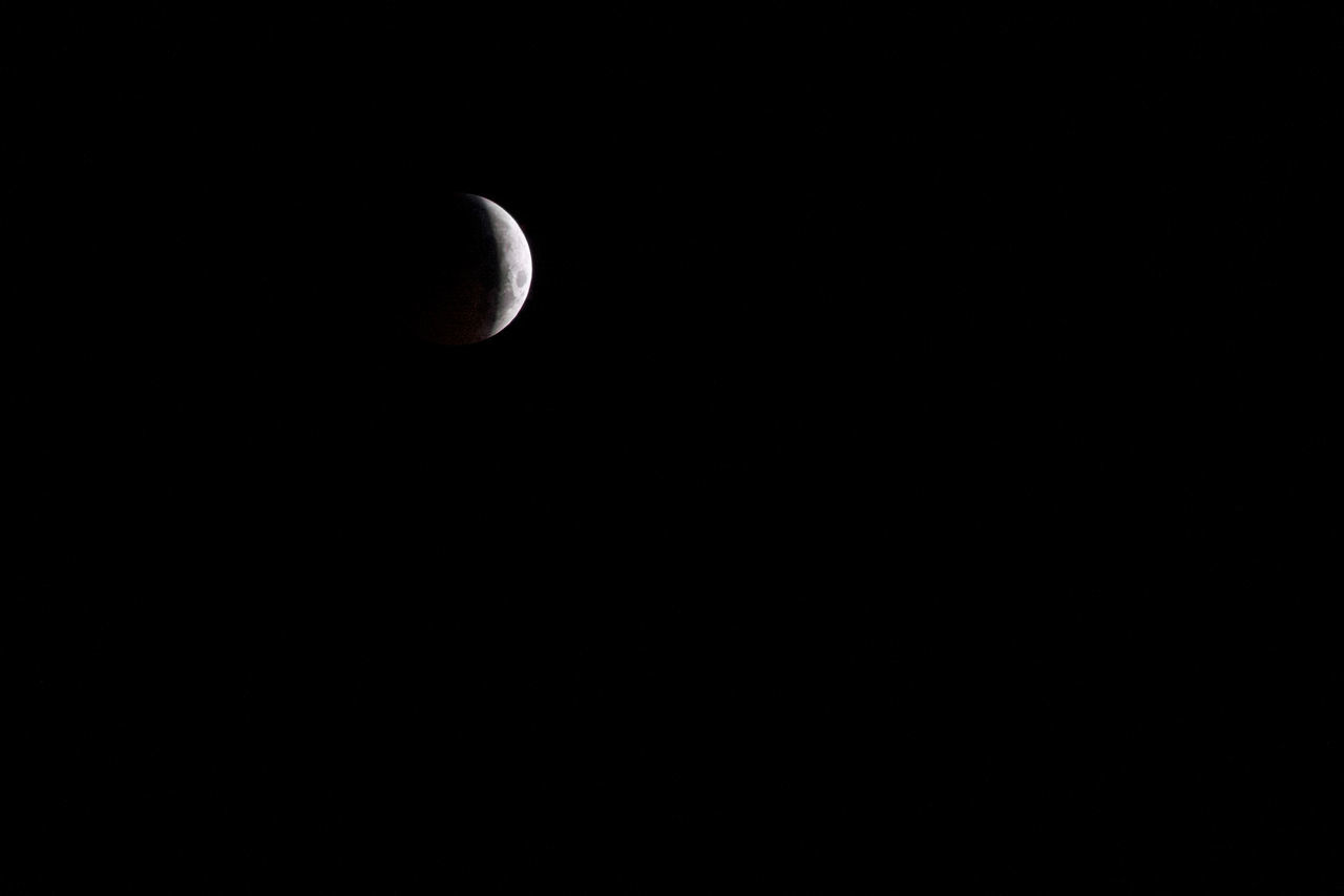 LOW ANGLE VIEW OF MOON IN SKY