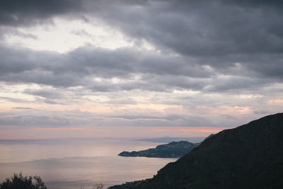 Scenic view of dramatic sky over sea during sunset