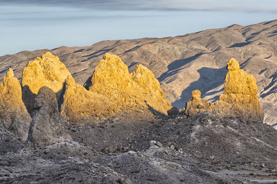 Panoramic view of rocks on beach against sky