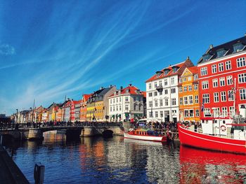 Canal passing through buildings in city