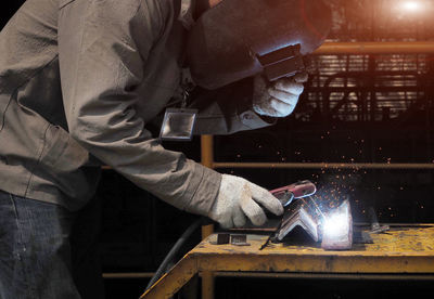 Man working on metal grate