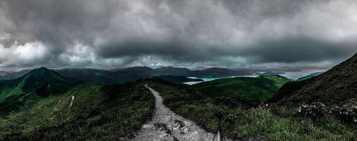 Scenic view of mountains against storm clouds