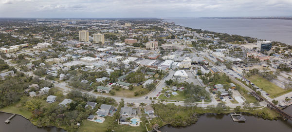 High angle view of townscape by sea against sky