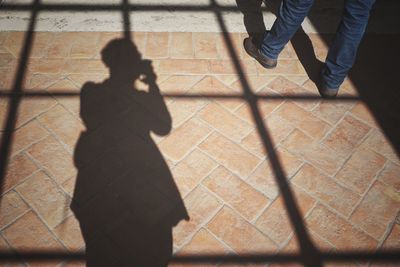 Low section of people standing on tiled floor