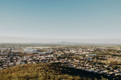 High angle view of buildings in city against clear sky