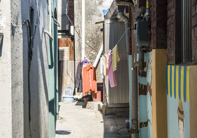 Clothes drying on alley amidst buildings